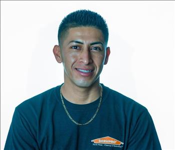 Man in SERVPRO uniform posing for a picture on a white background