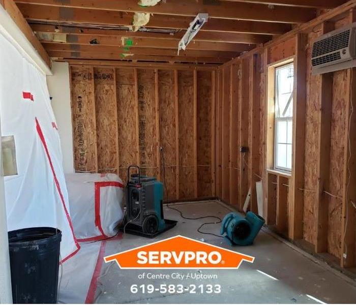 A water-damaged room is undergoing restoration.