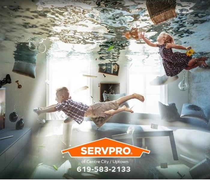 Children swim in a living room inundated by water.