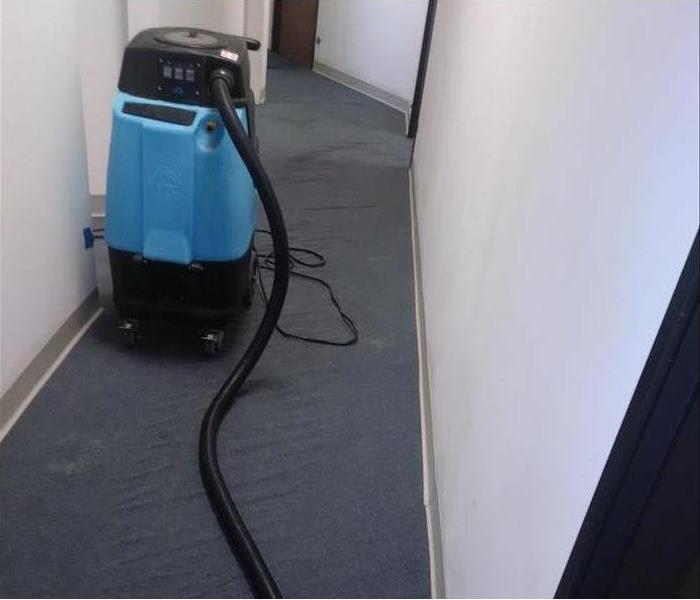 Blue drying equipment in a San Diego commercial building, drying carpet